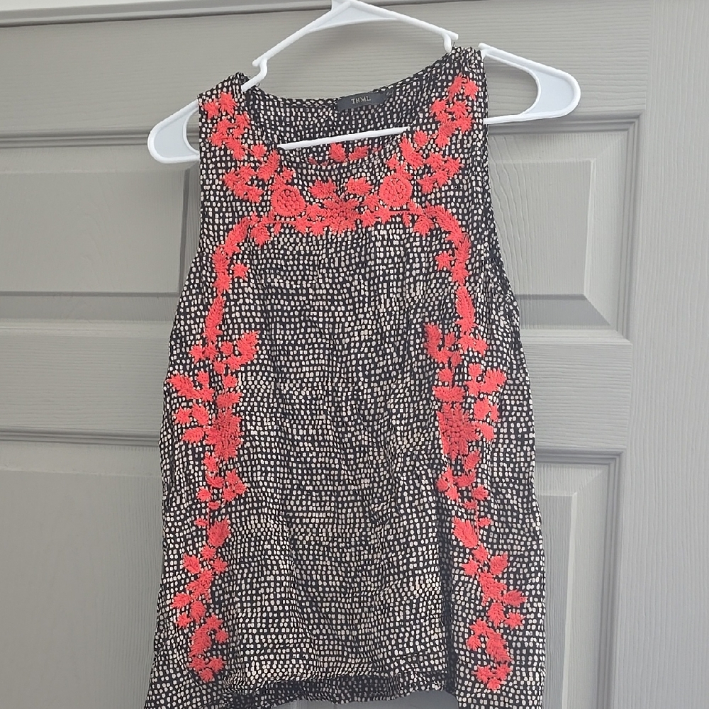 Black and White Sleeveless Top with Red Floral Design